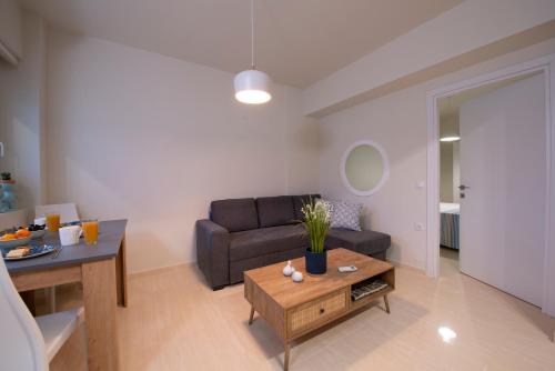 a living room with a couch and a table at Creta Vivere Villas in Agia Pelagia