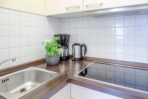 a kitchen with a sink and a counter top at Vik1_23 in Westerland (Sylt)