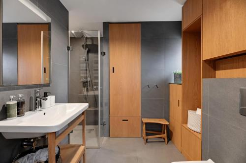 a bathroom with a sink and a shower at City & Old Town View Rooftop by Downtown Apartments in Gdańsk