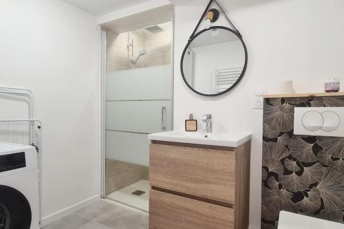 a bathroom with a sink and a mirror at L'échappée Belle in Bessines