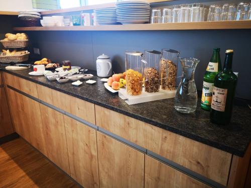 a buffet with food and drinks and bottles of wine at Frühstückspension Ochnerbauer in Kindberg