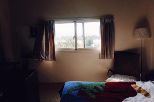 a bedroom with a bed and a window at Puli Islet Inn in Puli