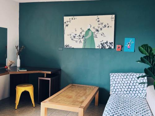 a living room with a table and a chair at Puli Islet Inn in Puli