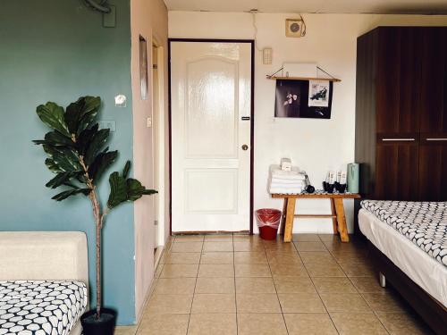 a bedroom with a door and a potted plant at Puli Islet Inn in Puli
