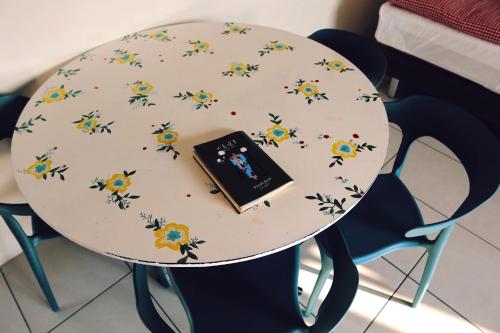 a table with flowers on it with a book on it at Puli Islet Inn in Puli