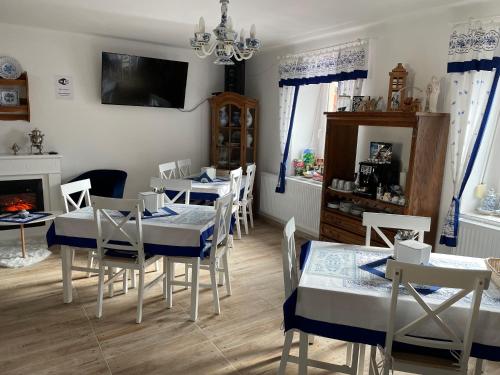 a dining room with tables and chairs and a fireplace at Ubytování U Synagogy Dobříš in Dobříš