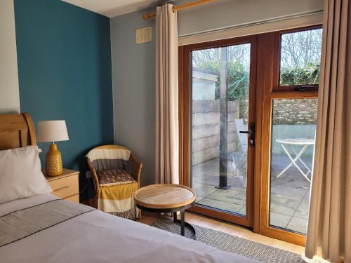 een slaapkamer met een bed en een glazen schuifdeur bij Aonach in Dingle