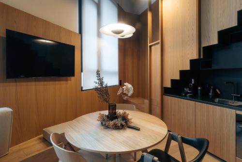 a room with a table with chairs and a television at Andermatt Alpine Apartments in Andermatt