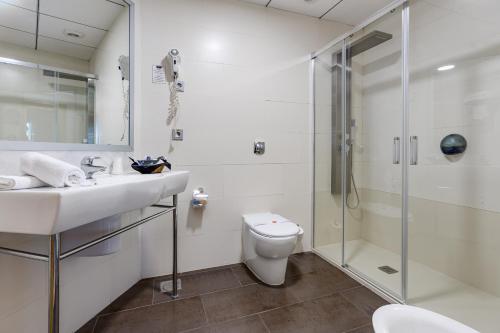 a bathroom with a shower and a sink and a toilet at Daniya Alicante in Alicante