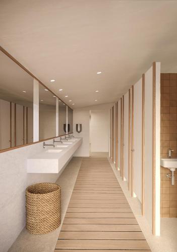 a bathroom with two sinks and two mirrors at wecamp Cadaqués in Cadaqués
