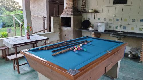 a pool table with cue balls on top of it at Sítio das Valquírias in Taquaraçu