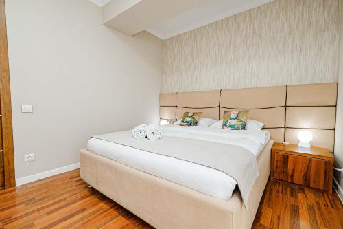 a bedroom with a large bed in a room at The Central Collection Apartments in Chişinău