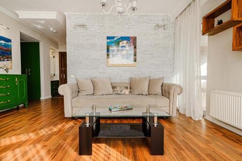 a living room with a couch and a table at The Central Collection Apartments in Chişinău