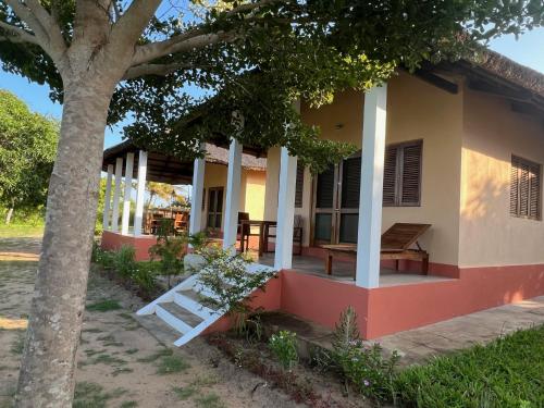 a house with a tree in front of it at Villa Moringa lodge in Lumbo