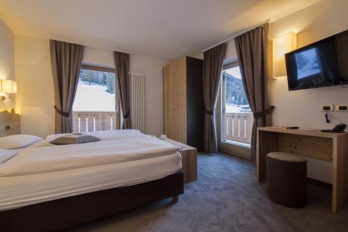 Ein Bett oder Betten in einem Zimmer der Unterkunft Hotel Garni Lastei