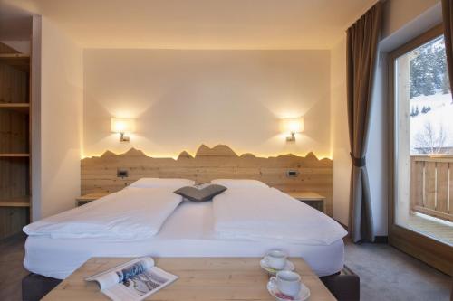 Ein Bett oder Betten in einem Zimmer der Unterkunft Hotel Garni Lastei