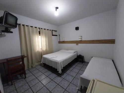 Un ou plusieurs lits dans un hébergement de l'établissement Palace Hotel Jacarezinho
