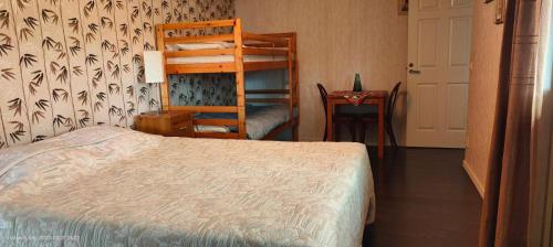 a bedroom with a bed and a bunk bed at Family room in Trönninge