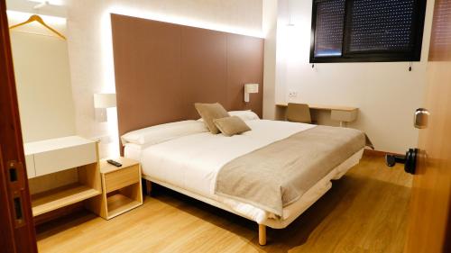 Postel nebo postele na pokoji v ubytování Hotel Ocamiño