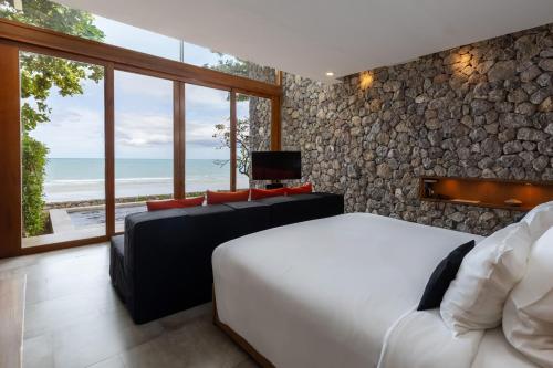 a bedroom with two beds and a view of the ocean at Tolani Resort Kui Buri in Kui Buri