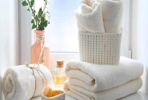 a stack of towels on a table with a window at ApartHotel Riviera - Hyper Centre Ville - Studio Supérieur AC avec balcon et aperçu mer - BALCON MASSENET 1 in Nice
