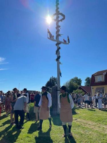 a group of people standing in front of a cross at Homestay in picturesque village in Nusnäs