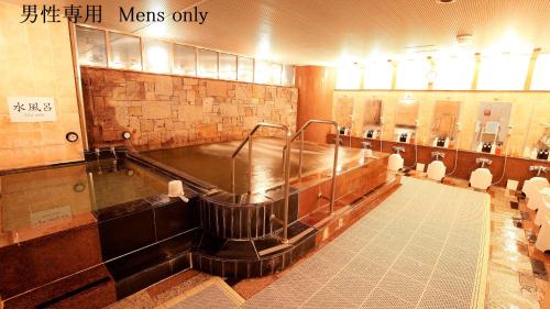 a large bathroom with a large tub in it at Asakusa Central Hotel in Tokyo