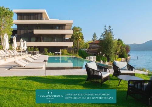a resort with a swimming pool and chairs and a building at Laqua by the lake in Pettenasco