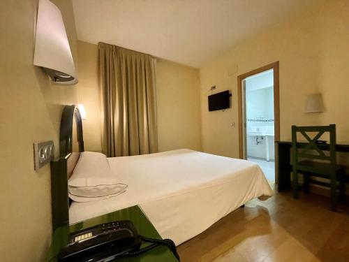 Ένα ή περισσότερα κρεβάτια σε δωμάτιο στο Hotel Madrid Río