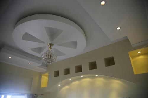 a ceiling with a chandelier in a room at Hotel Boutique Castillo del Mar in El Quisco
