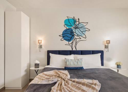 a bedroom with a blue bed with a flower on the wall at Rosalina Ocean Park in San Juan
