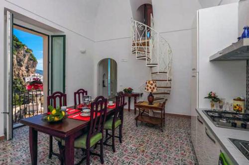 a kitchen and dining room with a table and chairs at Amalfi Antica in Atrani