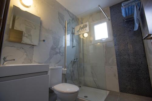 a bathroom with a shower and a toilet and a sink at Ayia Napa Holiday Apartment Ss1 in Ayia Napa