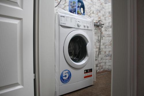 a washing machine in a room with a wall at Old Town Patio House in Ohrid