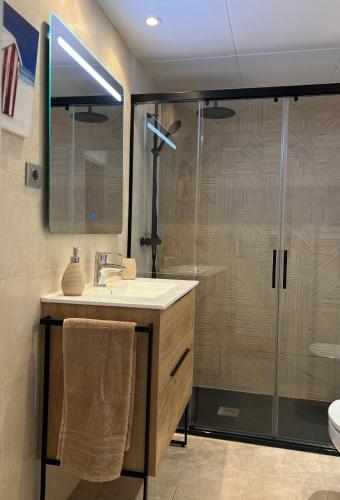 a bathroom with a sink and a glass shower at Musclera in Arenys de Mar