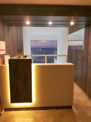 ナタールにあるApart Hotel Margheritaのカウンターと大きな窓のあるロビー