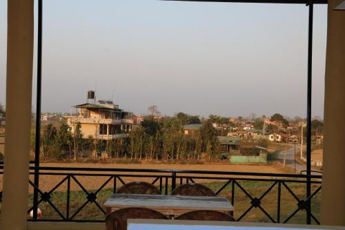 a view of a house from a balcony at Hotel National Park- A peaceful Family home where you can stay Peace and Enjoy and Organize the wildlife Safari in Chitwan