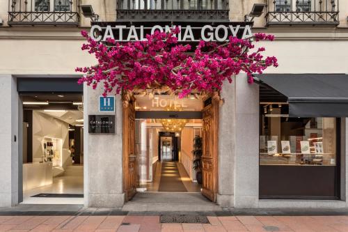 a store front with pink flowers hanging from it at Catalonia Goya in Madrid