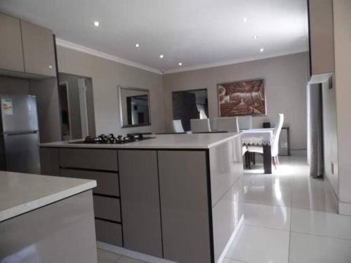 a large kitchen with white appliances and a dining area at Reflections at 21 in East London