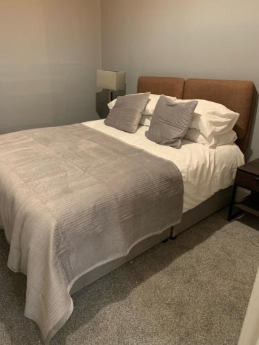 a bedroom with a large bed with white sheets and pillows at DS Study or Visit in Dundee