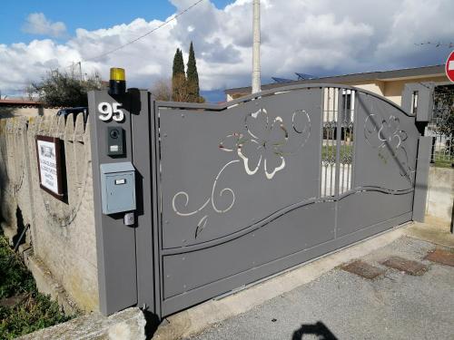 a gate with graffiti on it in front of a house at La Casa del Borgo-intero appartamento-cir22158 in Latina