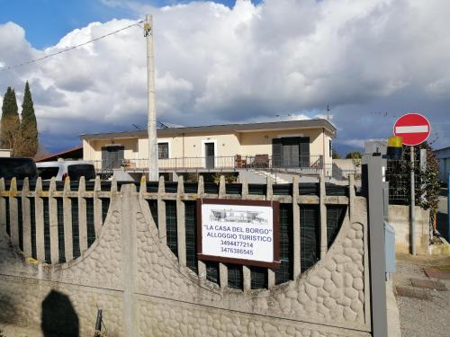 a sign on a fence in front of a house at La Casa del Borgo-intero appartamento-cir22158 in Latina