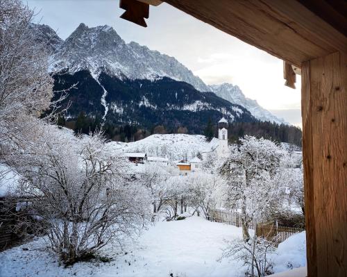 a view of a snow covered mountain from a cabin at Stefan Glowacz CHALET mit traumhaftem Bergblick in Grainau