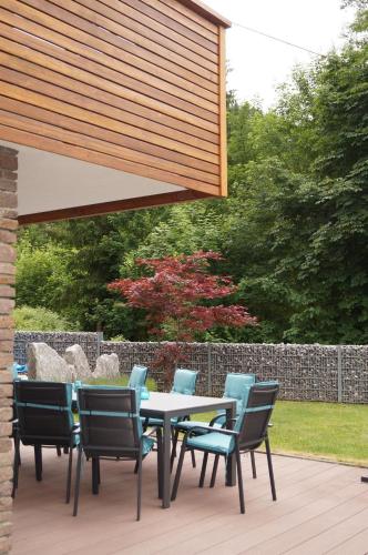 a patio with a table and chairs under awning at Haus Bambi in Achenkirch