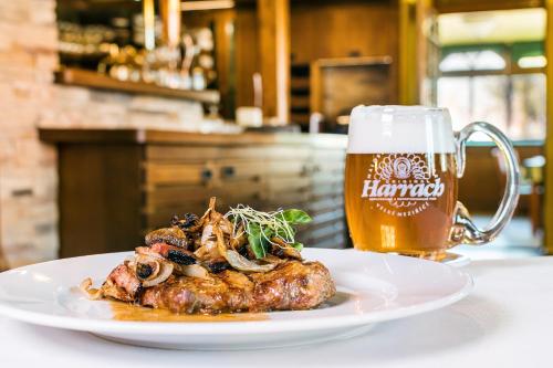 a plate of food and a glass of beer at Hotel Jelínkova vila in Velké Meziříčí