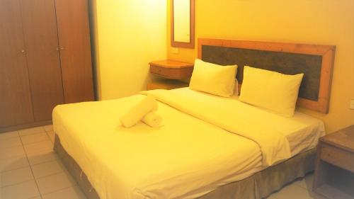 Una cama o camas en una habitación de Leo Palace Hotel