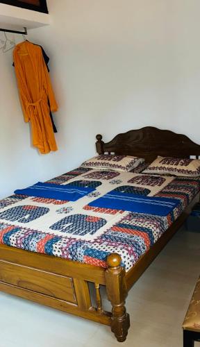 a bed with a quilt on it in a room at St francis xavier spacious rooms in Old Goa