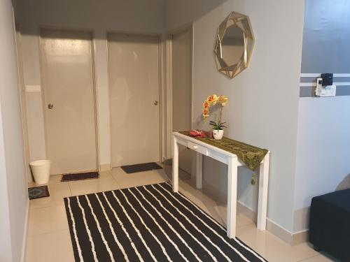 a small room with a table and a mirror at Apartment Servis UITM Puncak Alam in Bandar Puncak Alam