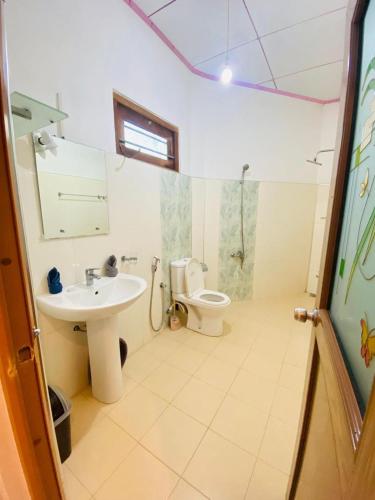 a bathroom with a sink and a toilet at Sanderling Silent Beach Cabanas in Tangalle