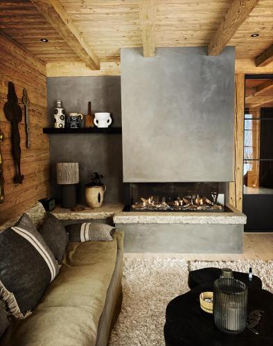 a living room with a couch and a fireplace at Stefan Glowacz CHALET mit traumhaftem Bergblick in Grainau
